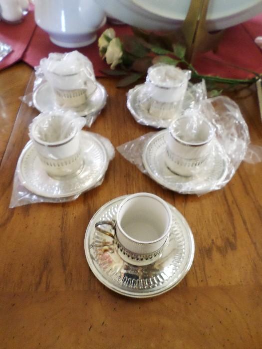Expresso porcelain cups in silver holders with silver underplates.  Set of spoons in box sold seperately