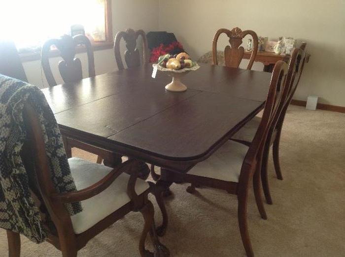 Beautiful claw and ball dining room table with new upholstered seats of the six chairs. Also comes with two leaves and custom made pads 