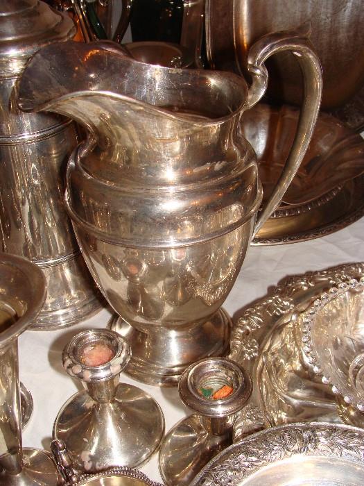 Sterling Silver Pitcher, candle holders and bowls.