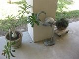 Egret statue and plants