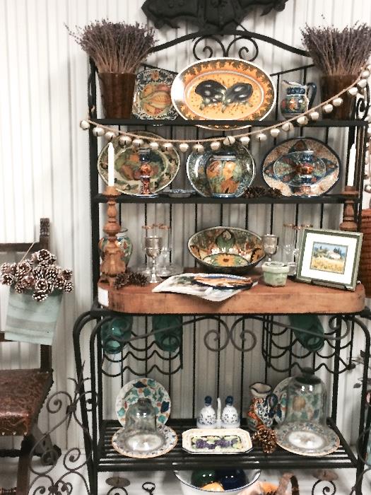 Bakers rack 7ft+ tall with wood butcher block table 3" thick, hold at least 8 bottles of wine in the holder under the butcher block. Beautiful fiesta ware dishes and candles. All dishes are either French, Italian or Mexican. 