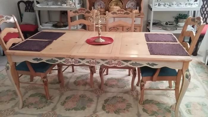 French table with two leaves and six chairs - great pastel chain-stitch rug. Five-light candelabra by Virginian Metalcrafters 