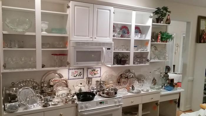 NICE kitchen FULL of silver plated holloware serving pieces, glassware, glass serving items, some Waterford, nice pots and pans, etc.