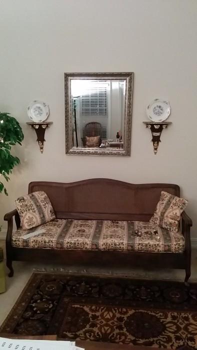 Nice frame on this cane-backed daybed, hand-woven 100% wool Talibur rug, silver-leaf beveled mirror, pIR OF HANDSOME WALL SCONCES