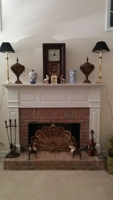 Antique wall clock, nice pair of brass candlestick lamps, antique cast iron andirons, brass fire tools, brass fan and flue pull, pair of decorative urns, etc.