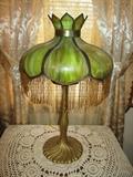 Antique slag glass lamp with beaded trim & cast iron base