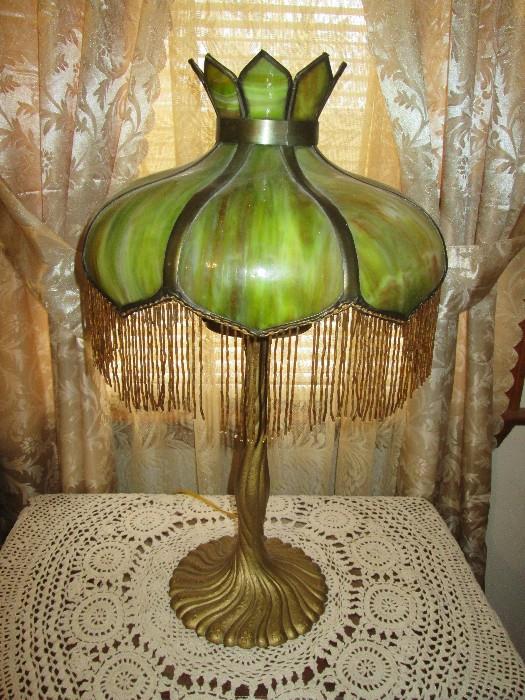 Antique slag glass lamp with beaded trim & cast iron base