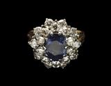 LOT 24: A SAPPHIRE, DIAMOND, AND 14 KARAT GOLD RING