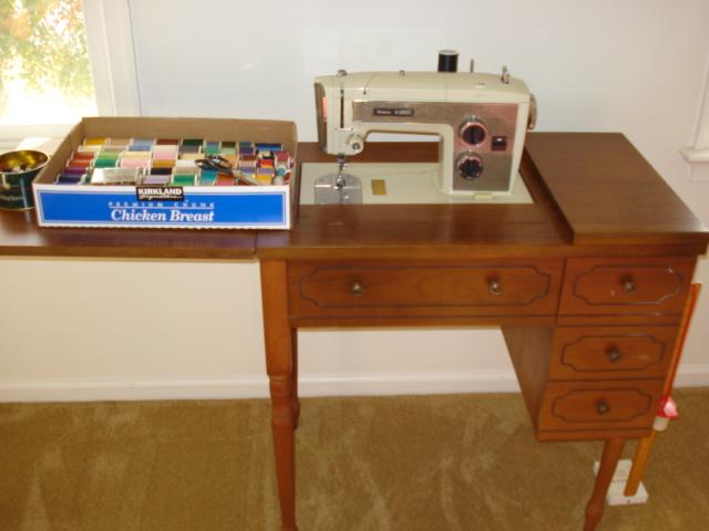 Kenmore sewing machine in cabinet, sewing supplies