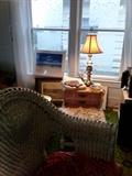 Comfy wicker chair, brass lamp. 