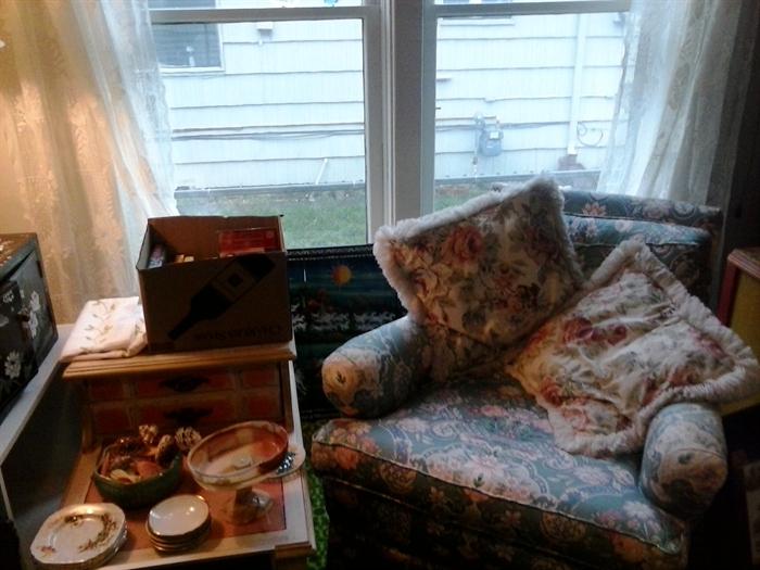 Upholstered arm chair, end table.