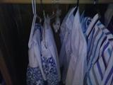 Pair of white/blue curtains.  Two men's cowboy shirts. 