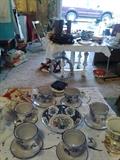 Various handthrown soup bowls with attached saucers.  Imari bowl in the center. Garage. 