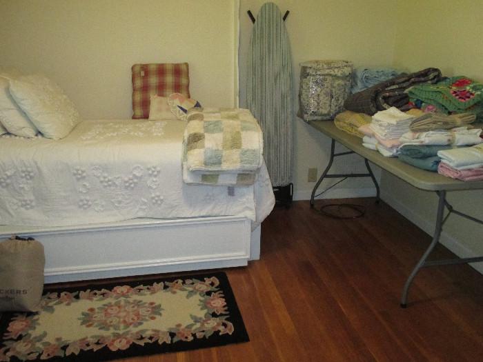 The Twin bed is a built in to the house and it's not for sale.  The bed spread, rug and blankets are!