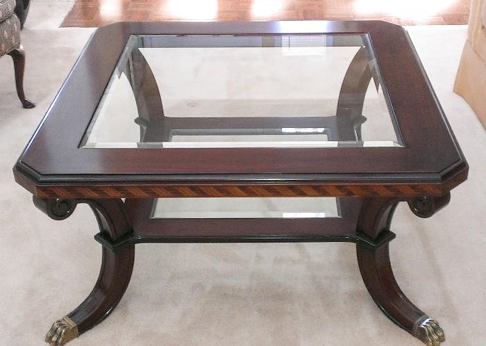 Square wood and glass coffee table with splay legs and brass feet.