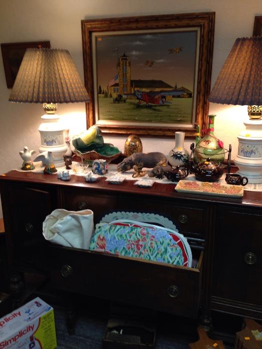 Antique sideboard with more lamps and collectibles.