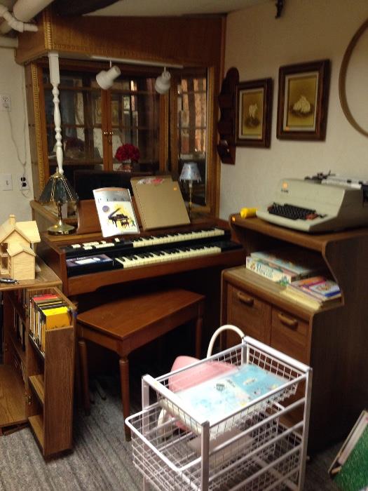 Electric organ and bench and rolling cabinets.