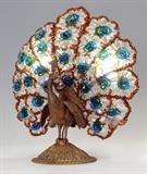 Lot 1012:  GILT BRONZE ART DECO CZECH PEACOCK LAMP: Gilt bronze figural peacock base with colored andclear crystal swags in tail. Overall 16 3/4'' h. x 15 1/4'' x 7''. Est. $1000/1500**
CONDITION: Has been re-wired.