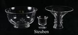 Lot 1327:  3 PIECE STEUBEN GLASS ITEMS: All 3 signed, clear glass to include 1) Footed center bowl with etched floral decoration, 4 1/2'' x 8'' dia. 2) Flared rim vase with applied decoration, 5'' h. x 7''. 3) Footed toothpick holder with twist base, 2 3/4'' h. x 2 3/4''.
CONDITION: #2 with scratches and abrasions to body, all with scratches to base.