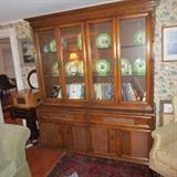 Oak bookcase cabinet uppercase with a plank top over four glass doors, lower case faux bamboo trim.  Woven wood doors