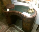 1940s kidney shaped mahogany desk with inset tooled leather top