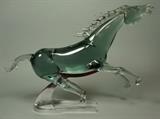 Lot 60:  Large Smoky Art Glass Horse Figural Sculpture. Stylized chrome horse shoe base. Not marked.: Dimensions:  H: 17 inches: W: 23 inches: D: 5 inches --- 