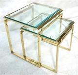 Lot 70:  Pr Brass Modernist Nesting Side Tables.  Beveled Glass Tops on Stylized brass bases. : Dimensions:  H: 22 inches: W: 20 inches: D: 18 inches --- 