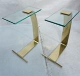 Lot 82:  DIA Brass Glass Cigarette Side Tables. Wide flat brass form supports thick glass top.  Not marked.: Dimensions:  H: 22.5 inches: W: 8 inches: D: 16 inches --- 
