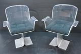 Lot 121:  Pr PACE style Molded Lucite & Aluminum Side Chair. Lucite acrylic shaped shell with flared arms. Flat pedestal base. Seat swivels. Black fabric seat cushion. : Dimensions:  H: 33 inches: W: 26 inches: D: 20 inches --- 