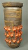 Lot 123:  Tall Pottery Vase Vessel. Brown finish with raised areas with orange coral glaze. Felt bottom. : Dimensions:  H: 19 inches: W: 9 inches --- US Shipping charge: $35