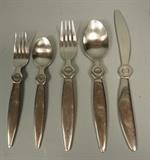 Lot 144:  MEKAEL BJORNSTJERNA Designs Modernist Flatware Set. 45pcs. Silver Plate with Target design. Knives shaped like propellers. Service for 8 plus extras. Marked: Sasaki. Korea : Dimensions:   --- US Shipping charge: $20