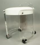 Lot 161:  Lucite Vanity Stool. White shiny vinyl seat cushion. 3/4" thick lucite. On wheels: Dimensions:  H: 20 inches: W: 18 inches --- 
