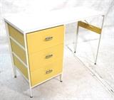 Lot 176:  Herman Miller by George Nelson Desk. Three drawers with yellow fronts. Metal pulls. Label. : Dimensions:  H: 30 inches: W: 42 inches: D: 17 inches --- 