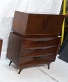 Lot 219:  American Modern High Chest Dresser. Deep triangular shaped details to drawer fronts. Horizontal wood pulls. Two doors over three drawers: Dimensions:  H: 51 inches: W: 41.5 inches: D: 19 inches --- 