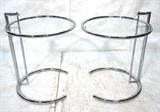 Lot 222:  Pr EILEEN GRAY style Side Tables. Chrome with Glass Tops. Adjustable height. Not marked.: Dimensions:  H: 24.5 inches: W: 20 inches --- 