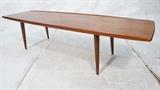 Lot 233:  Danish Modern Teak Coffee Cocktail Table. Raised Edge. Tapered Legs.  Nice style.: Dimensions:  H: 18 inches: D: 22 inches: L: 72 inches --- 