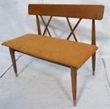 Lot 261:  American Modern Wood Bench Seat. Upholstered seat. "X" design back. Metal caps to feet: Dimensions:  H: 29.75 inches: W: 34.5 inches: D: 20 inches --- 