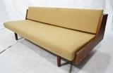 Lot 286:  HANS WEGNER Day Bed. Danish Teak. Gold gingham plaid upholstery. Sofa Couch becomes flip out bed. Thick wood column legs: Dimensions:  H: 29.5 inches: W: 78 inches: D: 36 inches --- 