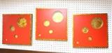 Lot 300:  set 3 Wall Art Pieces. Red squares with circle cut outs reveal metallic background.: Dimensions:  H: 17 inches: W: 17 inches --- 
