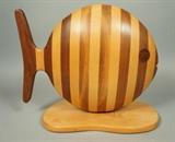 Lot 361:  GENE SHEARER Fish Form Wood Jewelry Box. Three drawers. Striped layered wood with inlaid wood eyes. American Studio Jewelry Box. Hand Crafted Artisan Woodworker. Signed 1984. #176. : Dimensions:  H: 14 inches: W: 16.25 inches: D: 7 inches --- US Shipping charge: $35