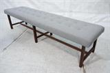 Lot 423:  Modernist Dunbar style Long Bench Gray Fabric tufted cushion top. Square dark wood legs: Dimensions:  H: 17.75 inches: W: 76 inches: D: 19 inches --- 