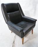 Lot 457:  DUX style Modernist  Lounge Chair. Black Leather on tapered peg legs. Wide Arms: Dimensions:  H: 37 inches: W: 31 inches: D: 32 inches --- 