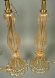 Lot 462:  Pr Murano Art Glass Table Lamps. Three part glass construction. Clear glass with internal gold flecks. Missing pad feet so the bottom rim rests on cord and causes lamp to not sit flat; needs little pads. Glass section is 16" H: Dimensions:  H: 26 inches: W: 6.25 inches --- 