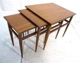 Lot 486:  Set 3 HERITAGE Walnut American Modern Nesting Tables. Rectangular tops. Tapered Legs. Nice Grain: Dimensions:  H: 22 inches: W: 21.5 inches: D: 25 inches --- 