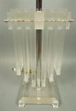 Lot 494:  70's Modern Lucite Table Lamp. Wide Flat Acrylic Hanging Panels. Matching finial. Chrome accents: Dimensions:  H: 32.5 inches: W: 11.5 inches: D: 8 inches --- 
