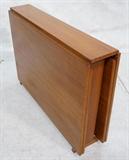 Lot 516:  Maria Style Danish Teak Folding Dining Table.  Very adjustable Goes from small to very large.  When fully open 109 inches.: Dimensions:  H: 28.5 inches: W: 8.5 inches: D: 39.5 inches --- 