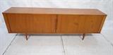 Lot 548:  Danish Modern Teak Credenza Sideboard Cabinet.  Tambour Doors.  Doors will not open all the way.  Replaced legs not original. : Dimensions:  H: 29 inches: W: 86.25 inches: D: 16.75 inches --- 