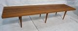 Lot 555:  American Modern Slat Bench Table. Six tapered peg legs. Mortise joints.: Dimensions:  H: 14 inches: W: 72 inches: D: 18 inches --- 