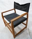 Lot 560:  Danish Modern Teak Collapsible Director's Chair. Angled teak frame. Brass clips & joints. Black vinyl seat.: Dimensions:  H: 29.5 inches: W: 21.5 inches: D: 21 inches --- 