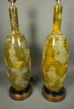 Lot 567:  Pr Green Pottery Table Lamps. Textured Finish. Gold tone metal base. Pottery is 23"H: Dimensions:  H: 38 inches: W: 7.25 inches --- 
